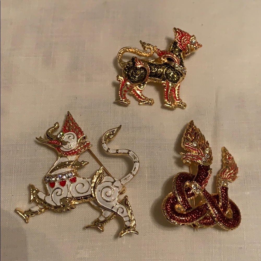 Three Asian Inspired brooches.